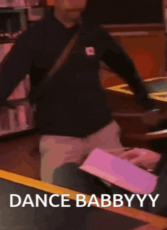 a man is dancing in a restaurant with the words dance babbyyy written on the bottom