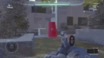 a person is playing a video game with a red cup in their hand