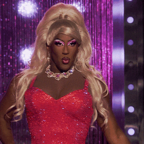 a drag queen wearing a red dress and necklace