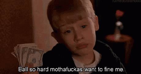 a young boy is sitting on a bed eating ice cream and saying `` ball so hard mothafuckas want to fine me '' .