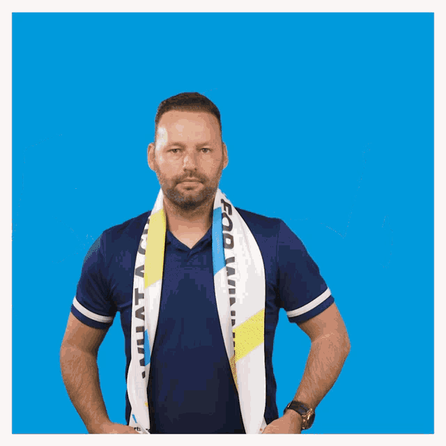 a man wearing an adidas shirt is holding a towel