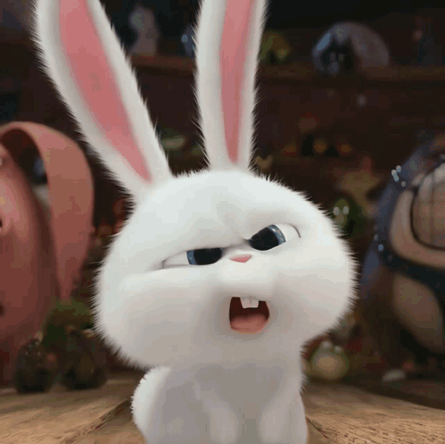a white rabbit with pink ears is sitting on a table with its mouth open