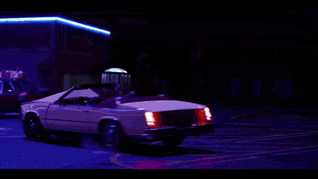 a car with its hood open is parked in a parking lot