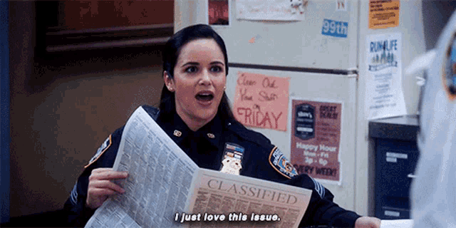 a police officer holds a classified newspaper and says i just love this issue