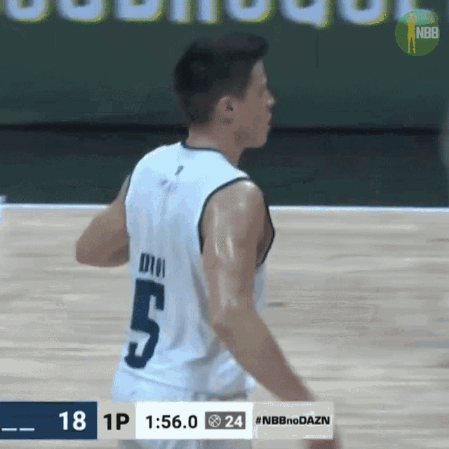 a basketball player wearing a number 5 jersey stands on the court