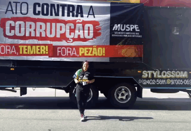 a woman is walking in front of a truck that says stylossom