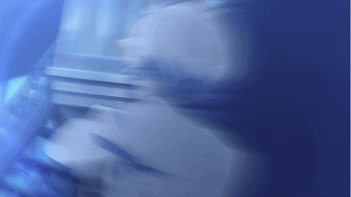 a blurry picture of a person 's face with blue background