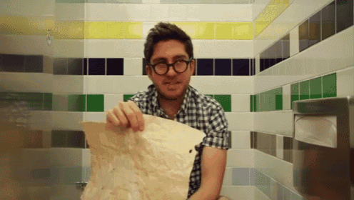 a man in a plaid shirt is holding a piece of paper