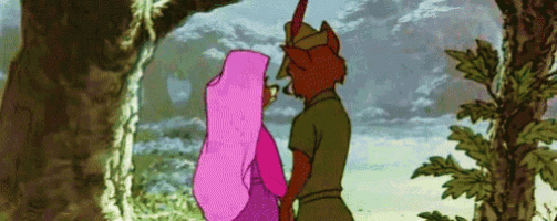 robin hood and princess aurora are kissing in the woods .