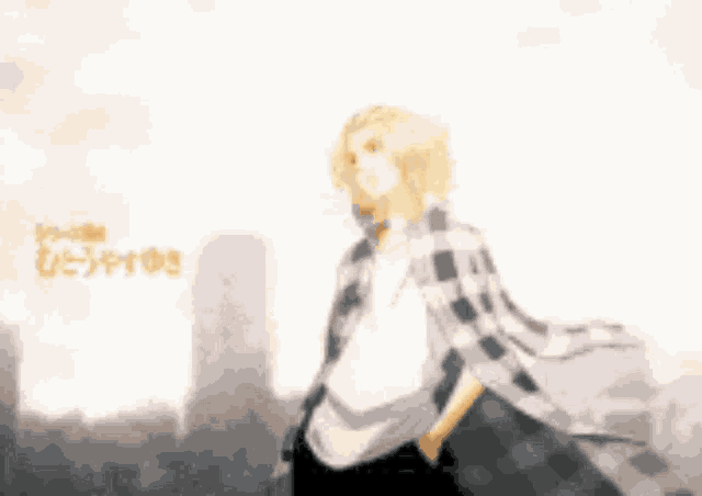 a man in a plaid shirt is standing in front of a city skyline .