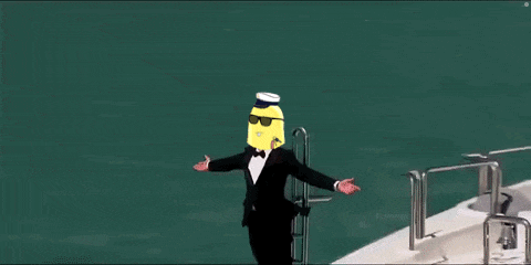 a man in a tuxedo with a banana on his head is standing on a boat .