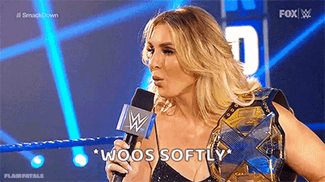 a woman is holding a microphone and talking into it .