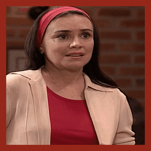 a woman is wearing a red headband and a white jacket