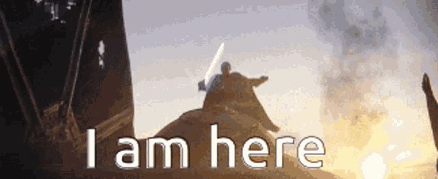 a man with a lightsaber is sitting on top of a rock with the words " i am here " written below him