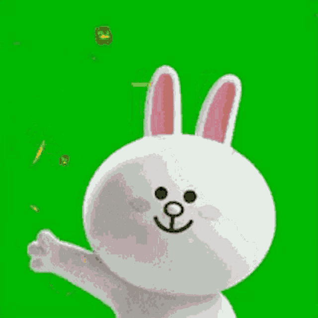 a white rabbit with pink ears is standing in front of a green screen