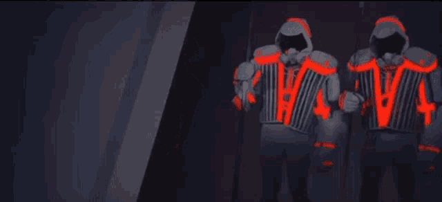 a group of people in glow in the dark costumes with the letter v on their vests