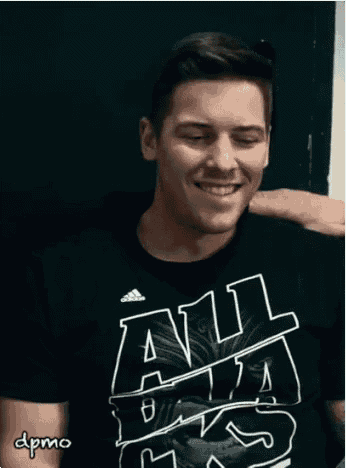 a man wearing a black shirt that says all star is smiling