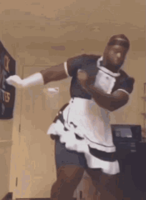 a man is dancing in a maid costume .