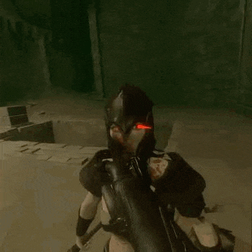 a woman in a black helmet and armor is standing in a dark room .
