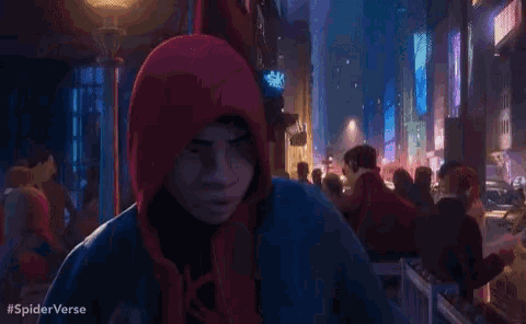 a man in a hooded jacket is standing in a crowded street with the words #spiderverse written below him