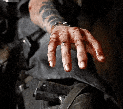 a close up of a person 's hand with a tattoo on the arm