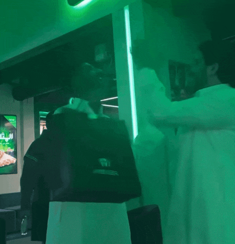 a man is holding a bag that says aigner