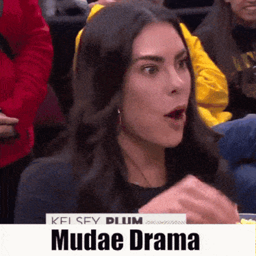a woman with a surprised look on her face is sitting in a crowd with the words mudae drama on the bottom