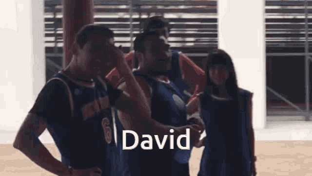 a group of basketball players are standing in a gym and the name david is on the bottom