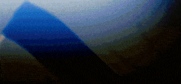 a blurry picture of a blue cube in a dark room