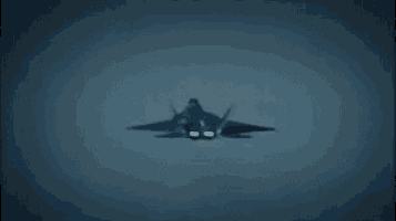 a fighter jet is flying in the sky with a kite attached to its tail .