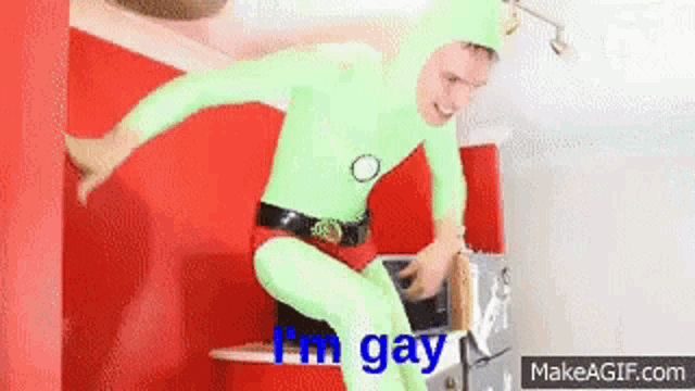 a man in a green suit says i 'm gay on make a gif