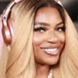 a woman is wearing headphones and smiling .