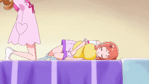 a girl in a pink dress is holding another girl on her back