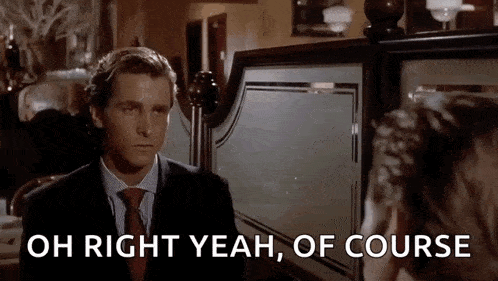 a man in a suit and tie is talking to another man in a restaurant and says `` oh right yeah of course '' .