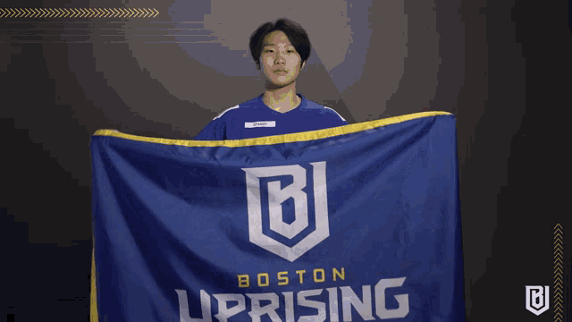 a man holding a boston uprising flag