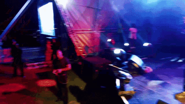 a blurry picture of a stage with purple and red lights