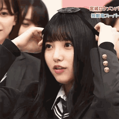 a girl wearing a headband with chinese writing on the bottom