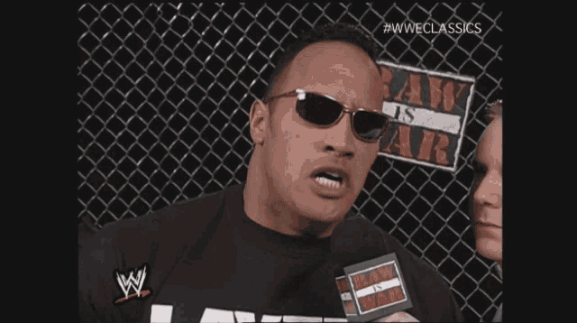 a man wearing sunglasses and a shirt that says ' layz ' on it