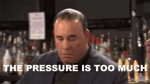 a man in a suit says the pressure is too much in front of a bar