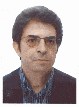 a man wearing glasses and a plaid shirt is looking at the camera