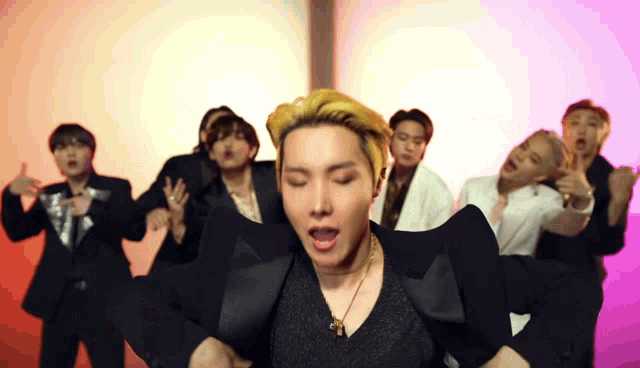 a group of men are dancing together in a room .