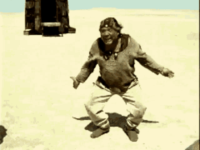 a man is dancing in the middle of a desert .