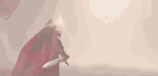a man in a red cape holding a sword