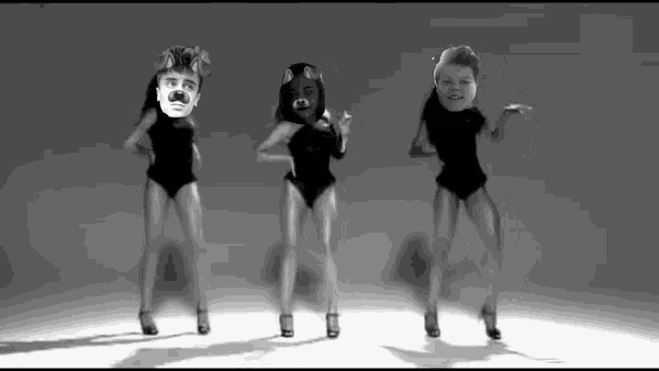 three people in swimsuits with faces on their heads are dancing