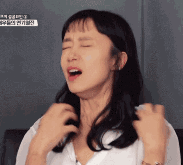 a woman is making a funny face in front of a sign that says ' 2 ' on it