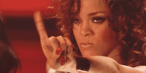 a woman with red nails is applying makeup to her face