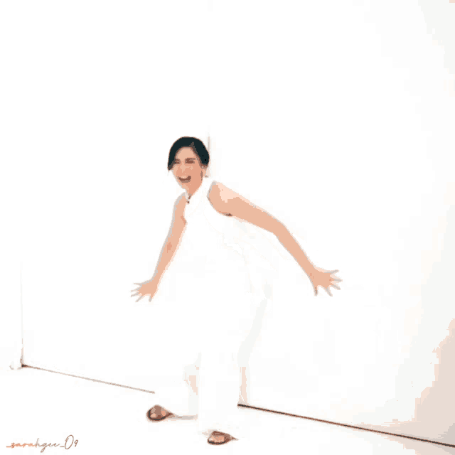 a woman in a white dress is making a funny face with sarahgee 09 written on the bottom right