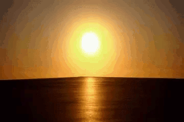 the sun is setting over the ocean and shining brightly
