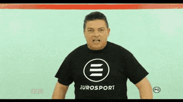 a man wearing a eurosport shirt stands in front of a green background