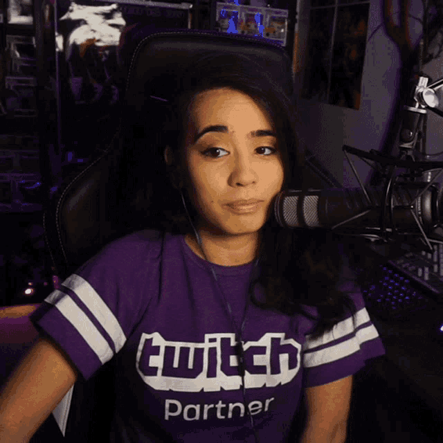 a woman wearing a purple t-shirt that says twitch partner